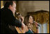 Singer Ana Cristina and guitarist Marco Linares perform on stage Friday, Oct. 6, 2006, in the East Room of the White House, in celebration of National Hispanic Heritage Month.