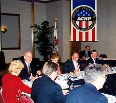 Several of the ACHP members sit around a table at the winter 2005 ACHP business meeting at the Portola Plaza Hotel in Monterey, California.