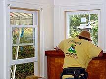 Man working on windows inside house, San Diego, California