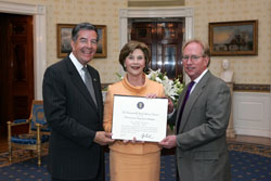 Mrs. Laura Bush poses for a photo with Preserve America Presidential Award winners, Larry Oaks, left, and David Gravelle May 12, 2008, in the Blue Room at the White House. White House photo by Joyce N. Boghosian