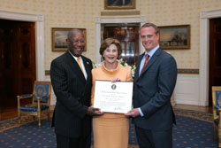Mrs. Laura Bush poses for a photo with Preserve America Presidential Award winners, Howard Dodson, left, and Mark Dremel May 12, 2008, in the Blue Room at the White House. White House photo by Joyce N. Boghosian