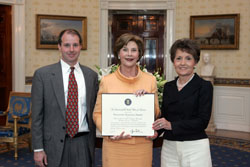 Mrs. Laura Bush poses for a photo with Preserve America Presidential Award winners, Gary Chandler, left, and Rosemary Williams May 12, 2008, in the Blue Room at the White House. White House photo by Joyce N. Boghosian