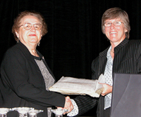 Dr. Gladys Reynolds (left) accepts the Elizabeth L. Scott Award from Dr. Linda J. Young (right), Chair, Committee of Presidents of Statistical Societies (COPSS) at the 2004 Joint Statistical Meeting held in Toronto in August, 2004.