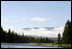 Clouds hang along the horizon as Vice President Dick Cheney casts a line in the waters of the Snake River in Idaho.