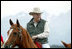 Framed by the snow-capped peaks of the Grand Tetons, Vice President Cheney tours the Wyoming countryside on horseback.