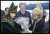 A Kazakh woman adorned in ceremonial dress welcomes Mrs. Lynne Cheney to Astana, Kazakhstan, with a bouquet of flowers, Friday, May 5, 2006.