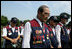 Members of the Korean War Veterans Association bow their heads during the invocation at the 2006 Korean War Veterans Armistice Day Ceremony, Thursday, July 27, 2006, at the Korean War Memorial in Washington, D.C.