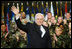 Vice President Dick Cheney waves in response to a warm welcome given by the troops and their families at a rally at Scott Air Base in Illinois, Tuesday, March 21, 2006.