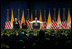 Pope Benedict XVI, joined on stage by Vice President Dick Cheney and Mrs. Lynne Cheney, gestures to the faithful Sunday, April 20, 2008 at a farewell ceremony for the Pope at John F. Kennedy International Airport in New York.