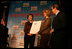 Mrs. Laura Bush presents fifth grade history teacher Maureen Festi, center, who teaches at Stafford Elementary School in Stafford, Conn., with the 2007 Preserve America National History Teacher of the Year Award at the Museum of the City of New York, Friday, Nov. 16, 2007 in New York. Dr. James Basker, president of the Gilder Lehrman Institute for American History looks on.