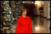 Mrs. Laura Bush walks from the White House Cross Hall into the East Room, Wednesday, Dec. 3, 2008, to begin the Christmas press preview of the White House decorations and preparations.