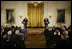 President George W. Bush and First Lady Laura Bush listen as Actor Avery Brooks, (L), and Dr. Allen Guelzo make remarks during a ceremony in the East Room of the White House honoring Abraham Lincoln's 199th Birthday, Sunday, Feb. 10, 2008.