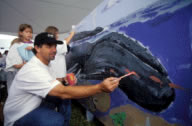 The world famous marine artist Wyland paints a mural alongside visitors at our annual Coast Day.  The mural is on display at the Hugh R. Sharp campus in Lewes.