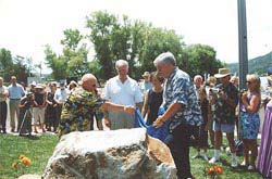 Picture of Rep. Thompson unveiling the Thompson Harbor dedication rock
