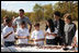 Mrs. Laura Bush listens as a child tells her about making seed balls speaks during a First Bloom Event at Trinity River Audubon Center, Sunday, November 2, 2008 in Dallas, TX. Mrs. Bush is joined by Benjamin Jones, Director of Education, Trinity River Audubon Center, left and singer/songwriter Kevin Jonas of the Jonas Brothers, right.