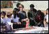 Surrounded by children Mrs. Laura Bush practices making seed balls during a First Bloom event at the Trinity River Audubon Center, Sunday, November 2, 2008, in Dallas, TX. Mrs. Bush is joined by singer/songwriters the Jonas Brothers, Kevin Jonas, Joe Jonas, and Nick Jonas, right.