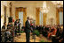 Mrs. Laura Bush listens as Berklee City Music group performs Friday, Nov. 14, 2008, during the Coming Up Taller Awards in the East Room of the White House.