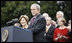 With Mrs. Laura Bush, the Vice President and Mrs. Cheney and Cabinet secretaries looking on, President George W. Bush addresses his staff Thursday, Nov. 6, 2008, on the South Lawn of the White House. Said the President, "As we head into this final stretch, I ask you to remain focused on the goals ahead. I will be honored to stand with you at the finish line."