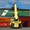 Cargo container being moved by machine