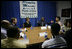 Laura Bush Secretary of Health and Human Services Mike Leavitt listen to Alphonso Pettis, Case Manager for Today's Dad's at Rosalie Manor Community and Family Services center in Milwaukee, Wis, Tuesday, March 8, 2005. Mr. Pettis is explaining in detail the pride he feels regarding the achievements of the young men sitting at the table, who, as teen fathers, have finished high school and found jobs.