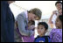 Laura Bush gives a hug to a student at Delisle Elementary School in Pass Christian, Miss., Tuesday, Oct. 11, 2005, as the school reopened for the first time since the area was struck by Hurricane Katrina.