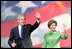 President George W. Bush and Laura Bush wave to young supporters during the pre-inaugural event 'America's Future Rocks Today- A Call to Service' youth event at the DC Armory in Washington, D.C., Tuesday, Jan. 18, 2005. The event highlighted the importance of volunteerism and community service in America's neighborhoods.