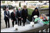 Laura Bush approaches a candle-lit memorial honoring the victims of the recent tsunami at the Embassy of Indonesia during a visit with President George W. Bush and former Presidents Bush and Clinton in Washington, D.C., Monday, Jan. 3, 2005.