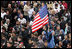 An American flag flies high above the throng of mourners inside St. Peter's square Friday, April 8, 2005, as thousands attend funeral mass for Pope John Paul II, who died April 2 at the age of 84.