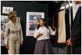Laura Bush looks at costumes designed by members of the Will Power to Youth program before watching a performance of "Romeo and Juliet" at the Shakespeare Festival/LA's theater in Los Angeles April 26, 2005. Students in the program write their own versions of Shakespeare's plays, create the music, costumes and construct the sets for each production.