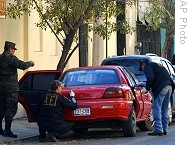 Police examine a car related to an attack on the television company Televisa in Monterrey, Mexico, 07 Jan 2009