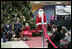 Mrs. Laura bush sits with patient escorts Issac Santana (age 12) and Amanda Merrell (age 5) along with Santa Claus (played by volunteer Jason Woods), while visting The Children's National Medical Center in Washington, D.C. and debuted 