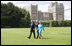 President George W. Bush and Laura Bush wave upon their arrival to Windsor Castle Sunday, June 15, 2008 in Windsor, England, escorted by Air Vice Marshal David Walker, where President Bush and Mrs. Bush met with Queen Elizabeth II and the Duke of Edinburgh Prince Phillip.