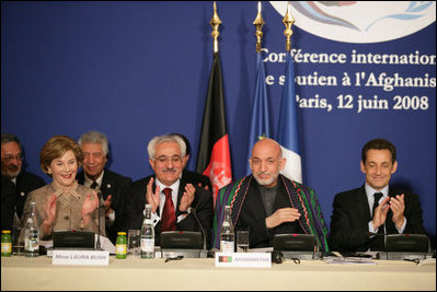 Mrs. Laura Bush joins in the applause during the International Conference in Support of Afghanistan Thursday, June 12, 2008 in Paris, where Mrs. Bush addressed the conference urging continued support for the Afghanistan people to build civic and economic institutions that can withstand the forces of oppression. Mrs. Bush is joined on the panel, from left, Afghanistan Foreign Minister Dr. Rangin Dadfar Spanta, Afghanistan President Hamid Karzai and French President Nicholas Sarkozy.