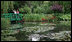 Mrs. Laura Bush tours the home and gardens of painter Claude Monet in Giverny, France. Mrs. Bush is accompanied by Mrs. Debbie Stapleton, in the red scarf, wife of the U.S. Ambassador to France Craig Roberts Stapleton, as she views Monet's inspiration for his water lilies paintings. Ms. Claire Toulgouat, left, leads the tour.