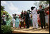 President George W. Bush and Mrs. Laura Bush take the stage with the Kankouran West African Dance Company after delivering remarks during a ceremony marking Malaria Awareness Day Wednesday, April 25, 2007, in the Rose Garden.