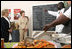 Mrs. Laura Bush listens to Fann Hospital staff members discuss their program that brings outpatients together for frequent communal meals and teaches nutritional cooking techniques Tuesday, June 26, 2007, in Dakar, Senegal.