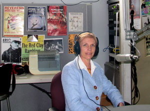 Tinkle relaxed after her interview on WCOM in a studio that serves many purposes for the Carrboro-Chapel Hill community radio station. 