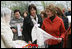 Mrs. Laura Bush spends a moment with a traditional handicraft artisan at Dimitrie Gusti Village during an outing Thursday, April 3, 2008, with NATO spouses to the Bucharest open-air museum.