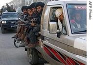 Taliban militants sit on their vehicle in Musa Qala in Afghanistan's Helmand Province, 2007 file photo