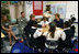 Mrs. Laura Bush shakes hands with student Taylor McIntyre, during her visit with students at the Good Shepherd Nativity Mission School, Thursday, Nov. 1, 2007 in New Orleans, a Helping America's Youth visit with Big Brother and Big Sisters of Southeast Louisiana. Captain Richard T. Douget, second from left, is a Big Brother to Taylor McIntyre.