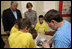 Mrs. Laura Bush visits with Taconi Elementary fifth graders Friday, Nov. 2, 2007, in Ocean Springs, Miss., prior to delivering remarks during the announcement of the Coastal Ecosystem Learning Center Designation and Marine Debris Initiative. The Marine Debris Initiative focuses on identifying, reducing and preventing debris in the marine environment through public and private partnerships, education and international cooperation.