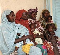 Women with children wait for care at village clinic in Chad