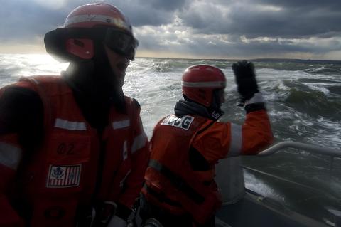 Petty Officer 3rd Class Felix Moreau and Seaman Louis Lopez of Coast Guard Station Sandy Hook, N.J., call out directions during a heavy weather man overboard drill off the coast of New Jersey, January 8, 2009.