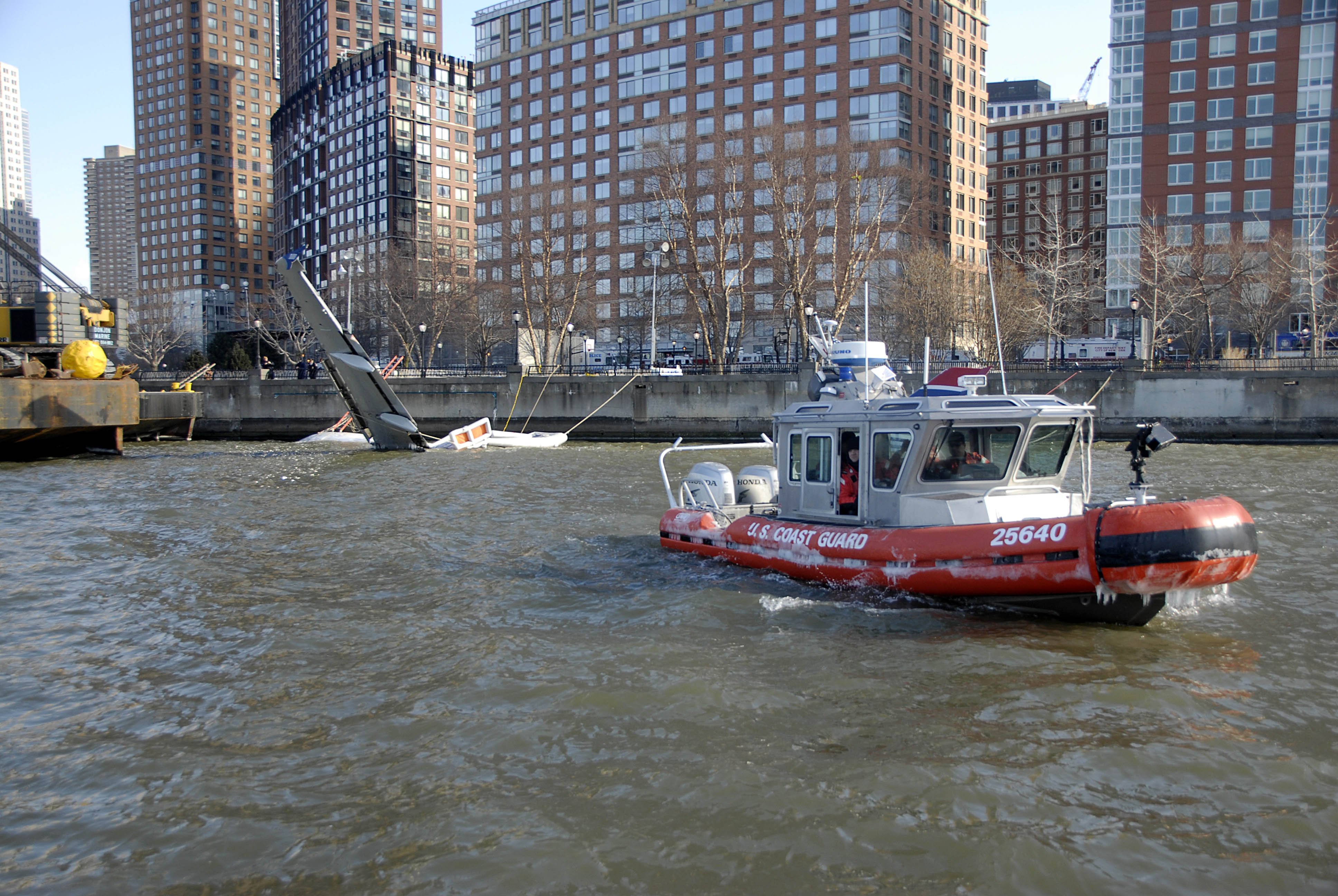 A rescue boat crew from Coast Guard Station New York enforces a security zone around a partially submerged US Airways plane in the Hudson River Jan. 16, 2009. The Coast Guard worked with the New York Police and Fire Departments and local ferry response teams to safely recover approximately 150 passengers after the airbus landed in the water. (U.S. Coast Guard photo/PA3 Barbara Patton)