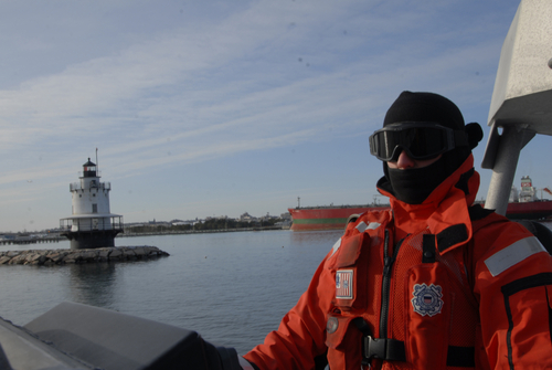 Photo of Petty Officer 2nd Class Brandon Perry conducting a routine patrol aboard a 47-foot motor life boat through chilly Portland Harbor, Thursday, Jan. 15, 2009. The crew bundled up to protect themselves from the 3 degree air and 39 degree water temperatures. 