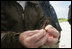 A Wildlife Biologist holds up a hook that was found in the stomach of a bird on Eastern Island. Human debris poses a significant danger to the many endangered species that live in the Midway Atoll National Wildlife Refuge.