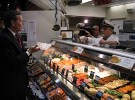 Secretary Leavitt tours the Reading Terminal Market in Philadelphia, where he visits with a merchant who sells imported seafood. Foreign products are sold throughout the market.