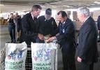 Secretary Leavitt pouring oregano into a paper bag in El Paso, Texas with Jack Grady, Consumer Safety Inspector of the Food and Drug Administration (FDA) within the U.S. Department of Health and Human Services (HHS), Luis C. Chavarría, Supervisory Investigator for the HHS Food and Drug Administration (FDA), and the Commissioner of the HHS Food and Drug Administration (FDA), Andrew C. von Eschenbach, M.D. (left). HHS photo by John Mallos