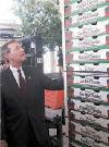 HHS Secretary Leavitt examines stacks of tomato boxes. Photo by Allyson Bell