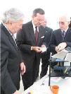 Secretary Leavitt observing a demonstration of a new X-ray spectrometer that can be used in the field to screen food and other products for toxic metals. HHS photo by John Mallos